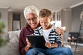 Grandfather and grandchild using digital tablet at home Royalty Free Stock Photo