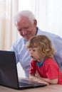 Grandfather and grandchild using laptop Royalty Free Stock Photo