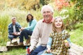 Grandfather And Granddaughter Blowing Bubbles Royalty Free Stock Photo