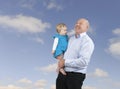 Grandfather and granddaughter, blue sky with clouds