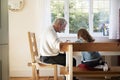 Grandfather And Granddaughter Colouring Picture Together Royalty Free Stock Photo