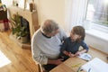 Grandfather And Granddaughter Colouring Picture Together Royalty Free Stock Photo
