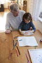 Grandfather And Granddaughter Colouring Picture Together Royalty Free Stock Photo