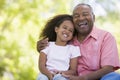 Grandfather and granddaughter outdoors smiling Royalty Free Stock Photo