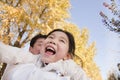 Grandfather and Granddaughter Playing in the Park, Laughing, in Autumn Royalty Free Stock Photo