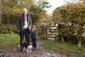 Grandfather And Granddaughter Taking Dog For Walk Royalty Free Stock Photo