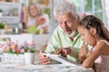 Grandfather with granddaughter using laptop Royalty Free Stock Photo