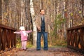 Grandfather with granddaughter on wooden bridge Royalty Free Stock Photo