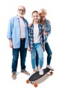 Grandfather, grandmother and happy granddaughter with skateboard
