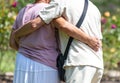 Grandfather and grandmother hugging in the park