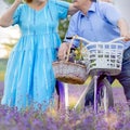 Grandfather and grandmother in a lavender field on a bicycle ride and relax together. Older Lifestyle 70
