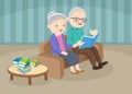 Grandfather with grandmother reading book together on sofa