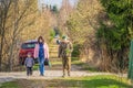 Grandfather and grandmother walk with their little grandson along the alley in nature Royalty Free Stock Photo