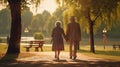 grandfather and grandmother walks in park. Back view. Hold hands