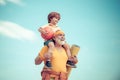 Grandfather and grandson with basketball ball and yoga mat in hands. Senior man and cute little boy exercising on blue Royalty Free Stock Photo