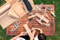 Grandfather and grandson building airplanes with recycled material cardboard, PVC bottles, wood. work ideas circular economy, re