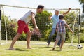 Grandfather, Grandson And Father Playing Football In Garden Royalty Free Stock Photo