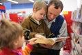 Grandfather and grandson and girl read book Royalty Free Stock Photo