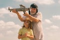 Grandfather and grandson having fun with toy plane on sky. Child dreams of flying, happy childhood with granddad. Family Royalty Free Stock Photo