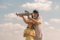 Grandfather and grandson having fun with toy plane on sky. Child dreams of flying, happy childhood with granddad. Royalty Free Stock Photo