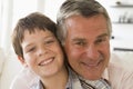 Grandfather and grandson indoors smiling Royalty Free Stock Photo