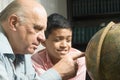 Grandfather and grandson looking at the globe