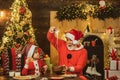 Grandfather and grandson make gingerbread cookies, near Christmas tree. Milk and gingerbread cookie for Santa against