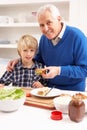 Grandfather And Grandson Making Sandwich Royalty Free Stock Photo