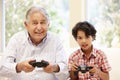 Grandfather and grandson playing computer games Royalty Free Stock Photo