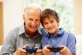 Grandfather and grandson playing computer games Royalty Free Stock Photo