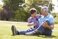 Grandfather And Grandson Playing Football In Garden Royalty Free Stock Photo