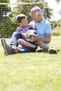 Grandfather And Grandson Playing Football In Garden Royalty Free Stock Photo