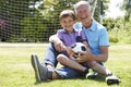 Grandfather And Grandson Playing Football In Garden Royalty Free Stock Photo