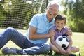 Grandfather And Grandson Playing Football In Garden Royalty Free Stock Photo