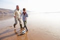 Grandfather And Grandson Playing Football On Winter Beach Royalty Free Stock Photo