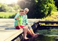 Grandfather and grandson sitting on river berth Royalty Free Stock Photo