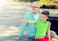 Grandfather and grandson sitting on river berth Royalty Free Stock Photo