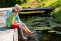 Grandfather and grandson sitting on river berth Royalty Free Stock Photo