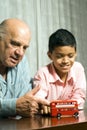 Grandfather and grandson sitting on table - Vertic