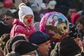 Grandfather and grandson in a street full of people