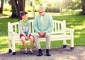 Grandfather and grandson talking at summer park