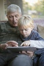 Grandfather and grandson using Tablet PC