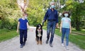 A grandfather and grandson are walking in the park with the dog during Coronavirus Pandemia Royalty Free Stock Photo