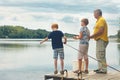 Grandfather and grandsons are fishing