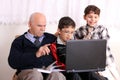 Grandfather, grandsons and notebook