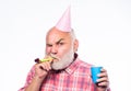 Grandfather graybeard blowing party whistle. Getting older is still fun. Elderly people. Birthday concept. Ideas for