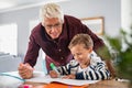 Grandfather help schoolboy doing homework Royalty Free Stock Photo