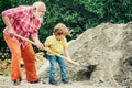 Grandfather with his grandson hard working. Little grandson helping his grandfather with building work. Child and works