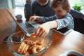 Grandfather and his grandson spending time insulated at home, stadying, watching cinema, shopping together