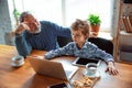 Grandfather and his grandson spending time insulated at home, stadying, watching cinema, shopping together